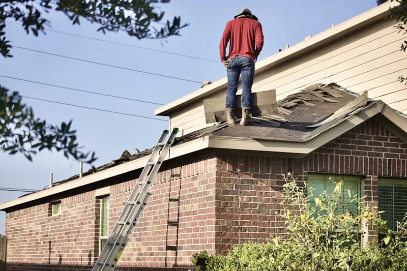 Professional roofer working on a residential roof in Marlain Acres